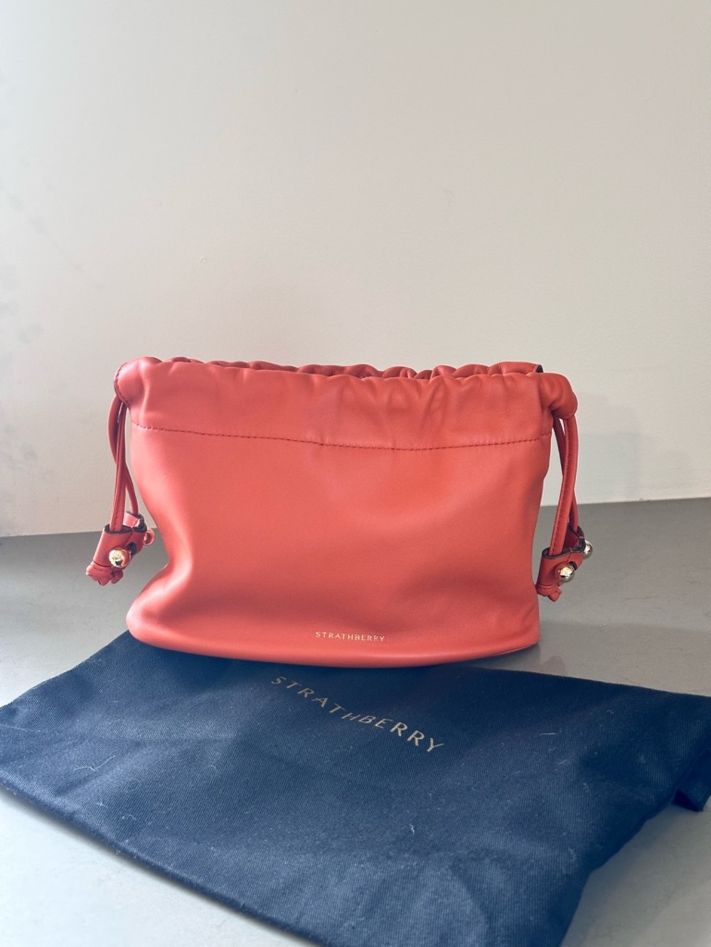 Strathberry Charlotte Orange Leather Drawstring Mini Pouch with Gold Accents - Picture 2 of 5
